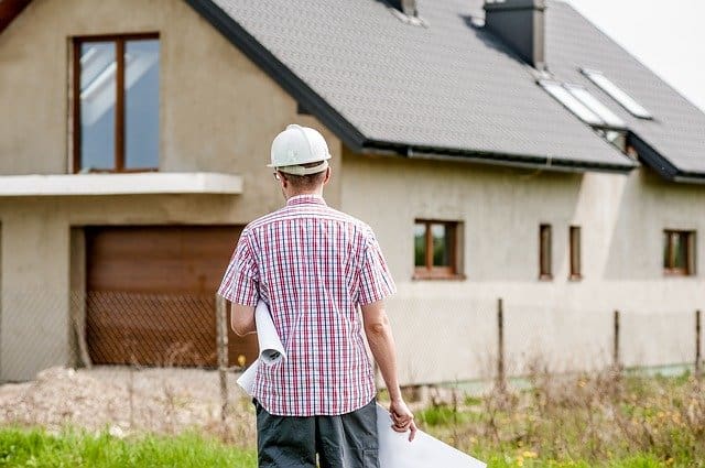 construction worker standing outside a house for external wall insulation