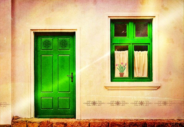 image of a green front door and window representing types of insulation for your home