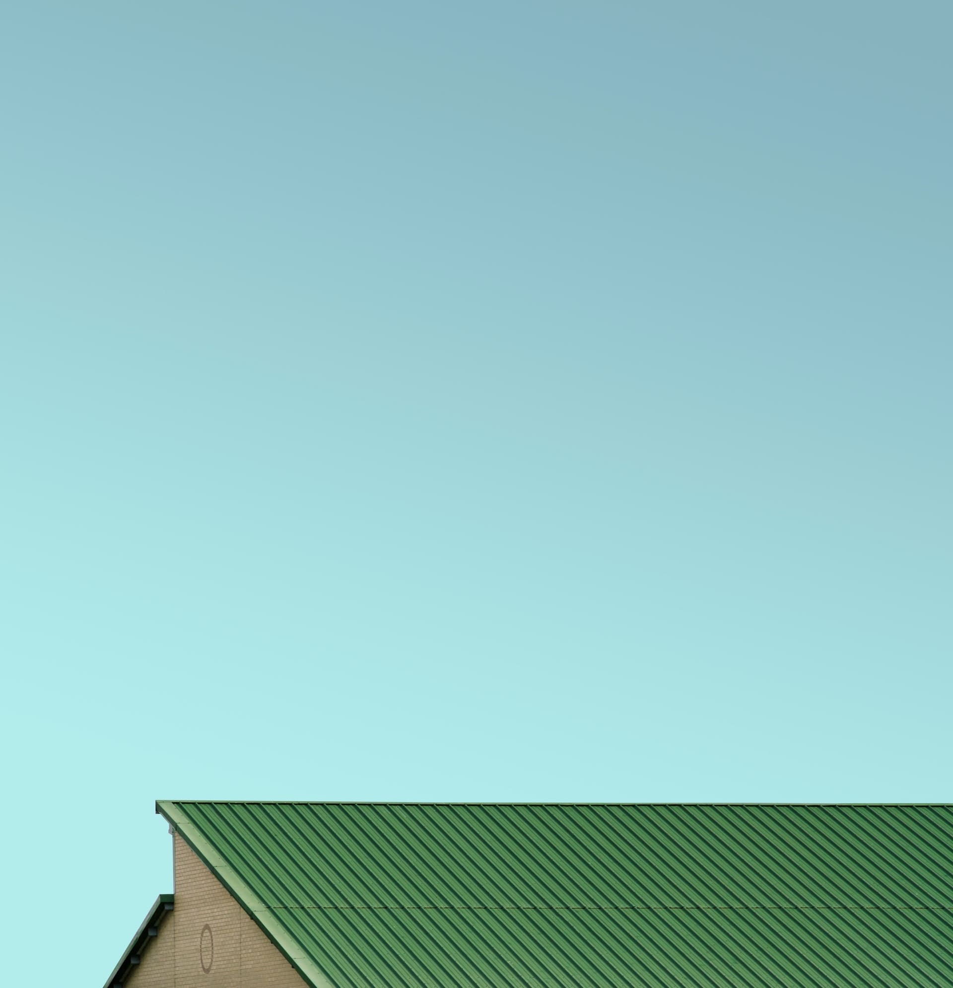 Biomass boiler overheating, green roof top with greenish blue sky in the background