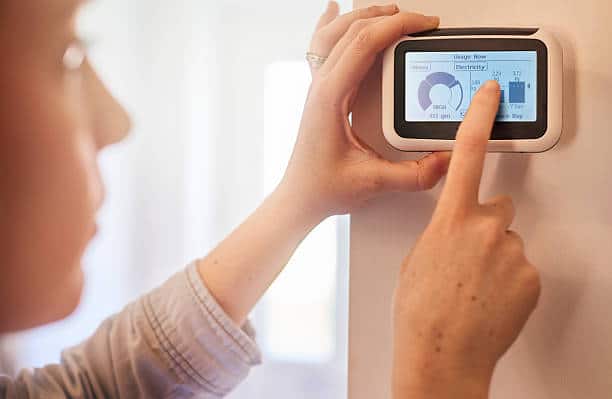 smart meter installation, woman setting up a smart meter at home